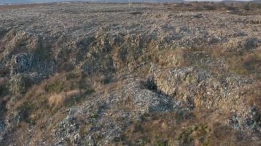 Aerial view of huge abandoned garbage dump. Landfill disposal site. Wastes of life and production. Environmental pollution.