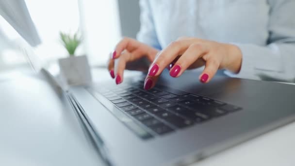Female hands typing on a laptop keyboard. Concept of remote work. — Stock Video