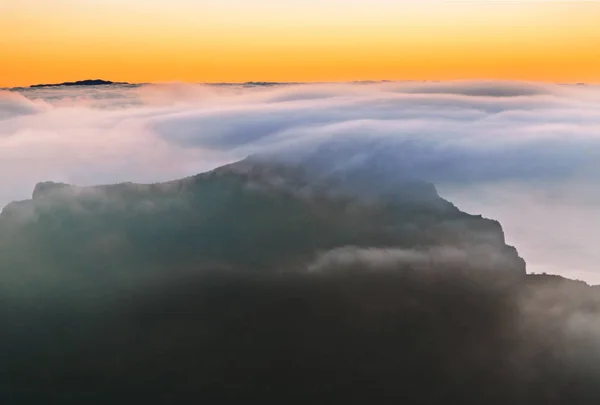 Sunset over the mountains in the clouds — Stock Photo, Image