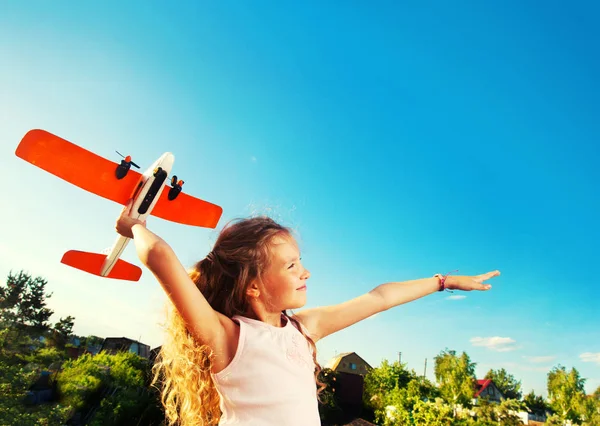 Girl playing with plane — Stock Photo, Image