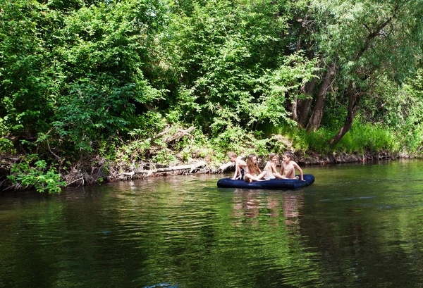 Children floating on the river — Stock Photo, Image