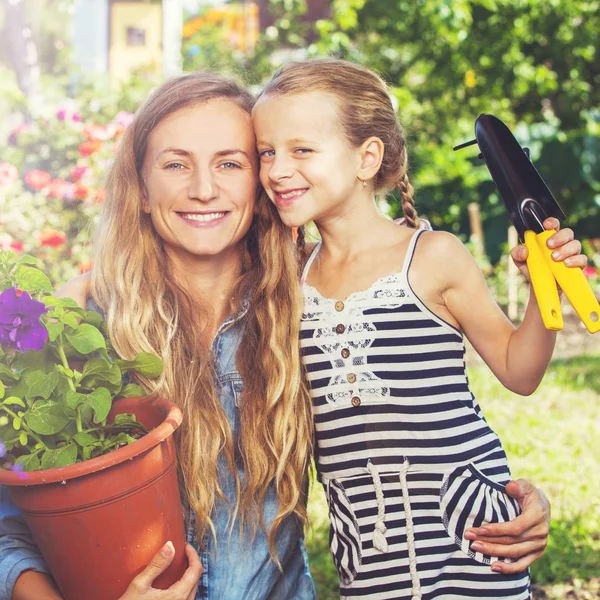 Woman and child working at garden — Stock Photo, Image