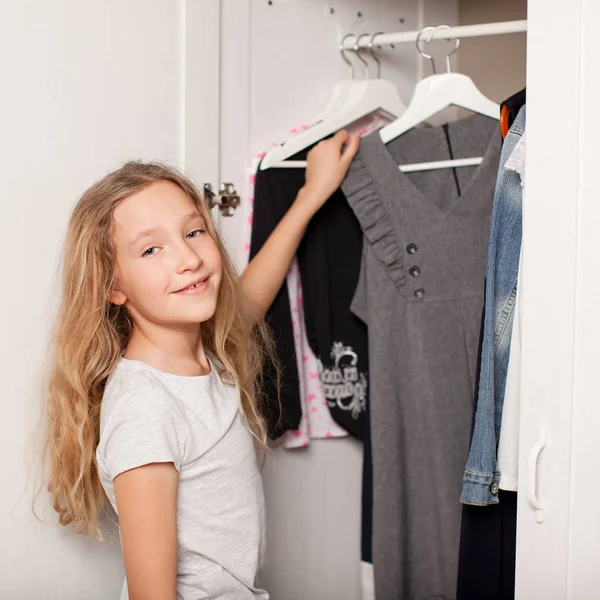 Child chooses clothes from the closet — Stock Photo, Image