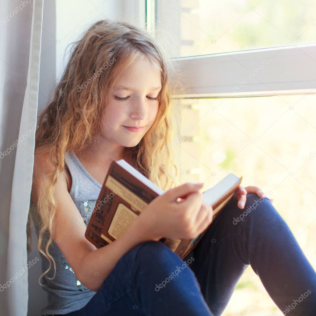 Girl reading book at home