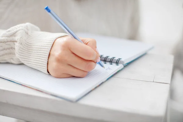 Woman writing pen in notebook Stock Image