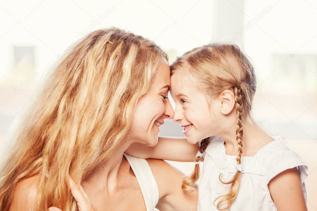 Happy family at home. Mother with child smiling