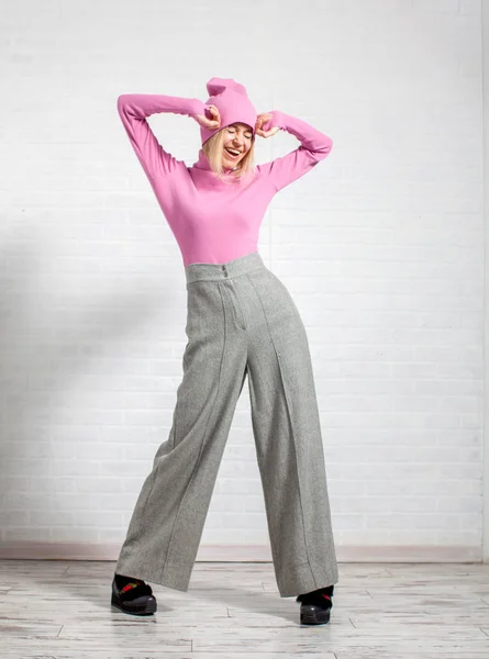 Woman in wide pants posing in studio — Stock Photo, Image