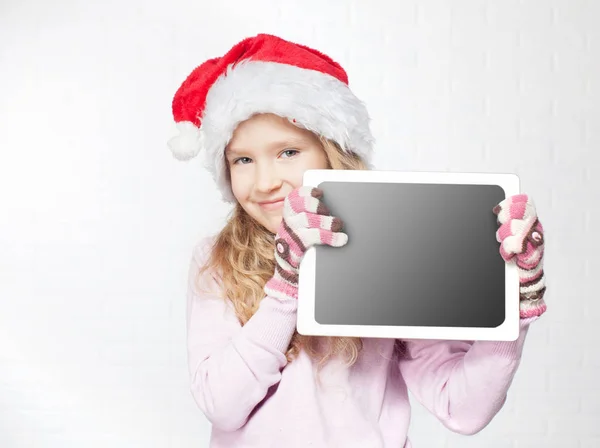 Kind in kerstmuts met Tablet PC — Stockfoto