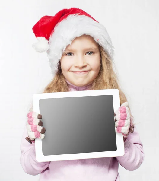 Child in christmas hat with tablet — Stock Photo, Image