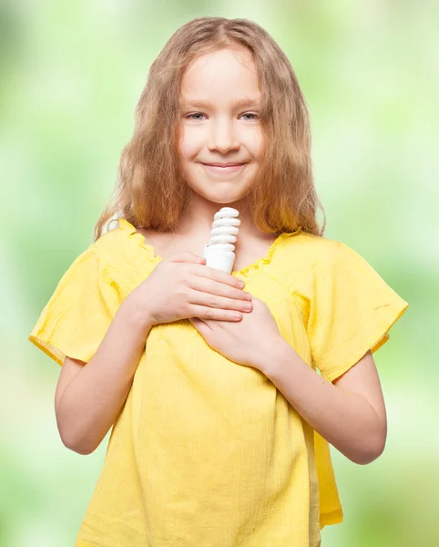 Girl holding an energy saving lamp — Stock Photo, Image