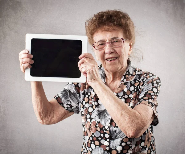 Vieja sosteniendo una tableta en las manos de —  Fotos de Stock