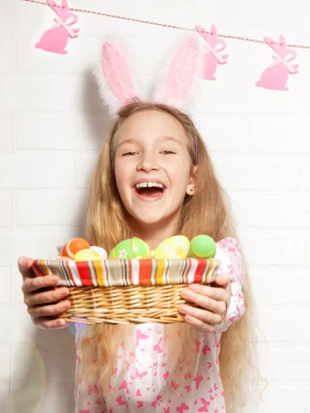 L'enfant tient un panier avec des œufs de Pâques — Photo
