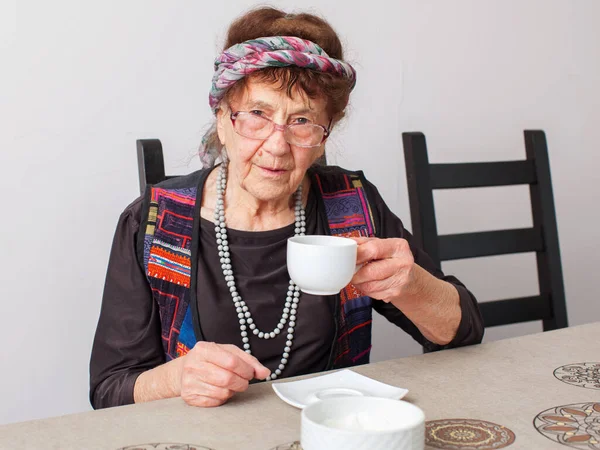 Old grandmother drinking tea — Stock Photo, Image