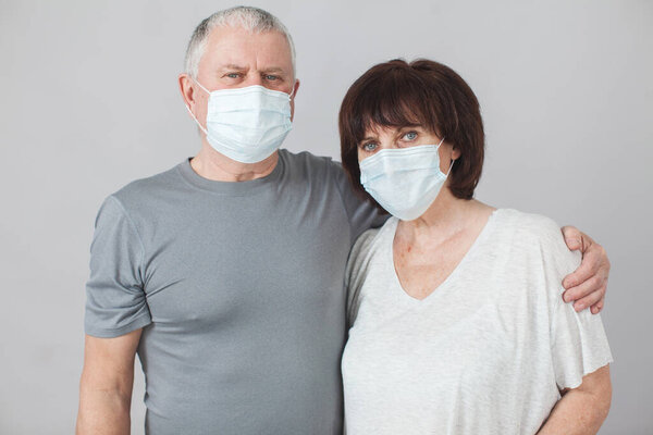 Couple of elderly people in medical masks in pandemic Coronavirus
