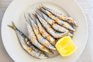 Freshly grilled sardines served with lemon. Torremolinos, Costa del Sol, Andalusia, Spain clipart