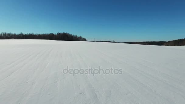 4K. Flight and takeoff above snow fields in winter, aerial panoramic view. Winter land in the north. — Stock Video