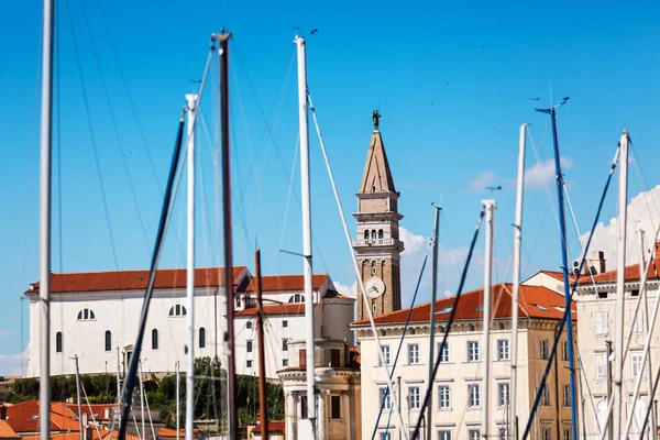Slovenya Piran eski şehir. Vith St. George's Parish Kilisesi bir koyda demirlemiş Yat Gemi direkleri ile göster — Stok fotoğraf