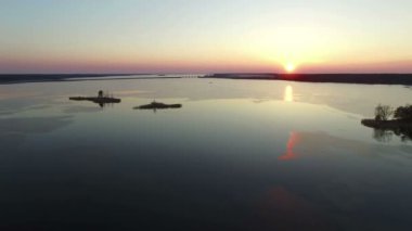 4 k derleme Video. Gün batımı, havadan görünümü üzerinde erken baharda bridge ile büyük donmuş göl üzerinde uçuş.