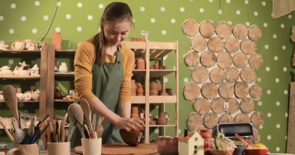 Adult female potter master preparing the clay on table — Stock Video