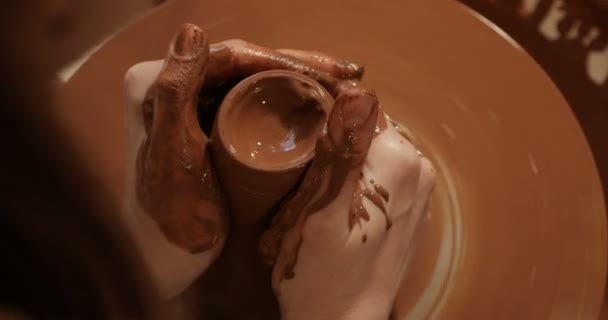 Close up of hands working clay on potters wheel, Top view, close-up view — Stock Video