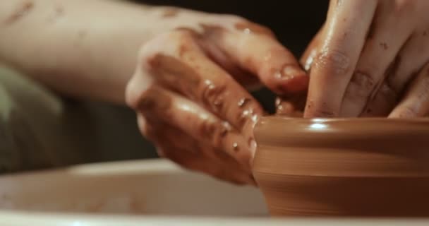 Close up of hands working clay on potters wheel, close-up view — Stock Video