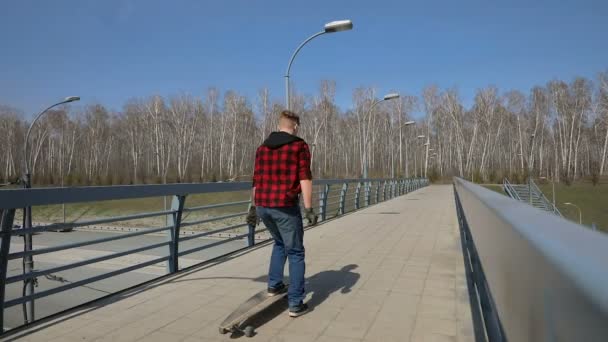 Cool guy on his longboard skate Over the bridge — Stock Video