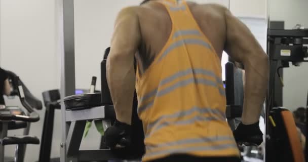 Handsome sporty man is exercising in gym centre — Stock Video