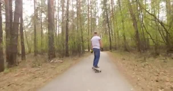 Facet na jego skate longboard. Shot śledzenia — Wideo stockowe