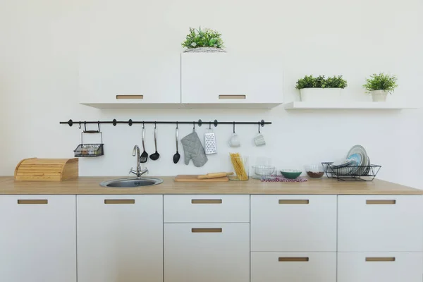 Şık minimalist mutfak ve yemek alanı iç görünümü. Hiçbir insan. Parlak mutfak arka plan. Parlak beyaz mutfak. Ahşap mutfak tezgahı