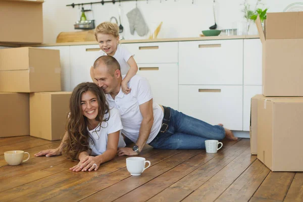 Lycklig familj planera sin nya lägenhet. Lycklig familj med pappkartonger — Stockfoto