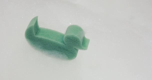Bathroom Rubber Ducklingr floats in water with copy space — Stock Video