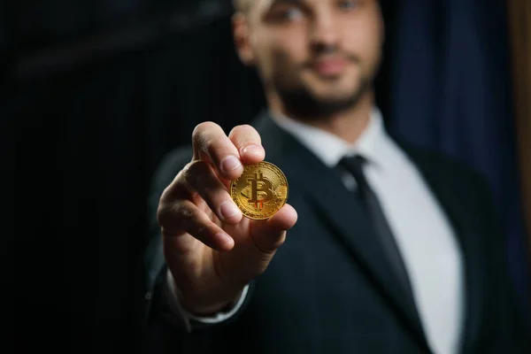 Businessman holding golden Bitcoin — Stock Photo, Image