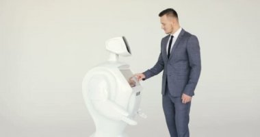 Şık bir adam bir robot ile iletişim kuran robot plastik mekanik bir kol presler el sıkışma. Sibernetik sistem bugün. Modern robotik teknolojiler. Özerk insansı robot. Beyaz arka plan