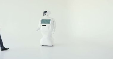 Şık bir adam bir robot ile iletişim kuran robot plastik mekanik bir kol presler el sıkışma. Sibernetik sistem bugün. Modern robotik teknolojiler. Özerk insansı robot. Beyaz arka plan