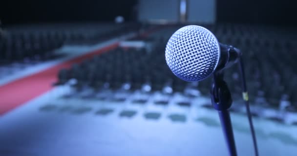 Close up Microphone on Stage at conference, Spotlight, Backlight. Waiting For Performances. Seminar Conference Meeting Office Training Concept. — Stock Video