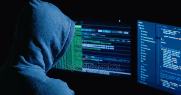 ハッカーがサイバー セキュリティ センター画面でいっぱいのコンピューターに取り組んでいます。. — ストック動画
