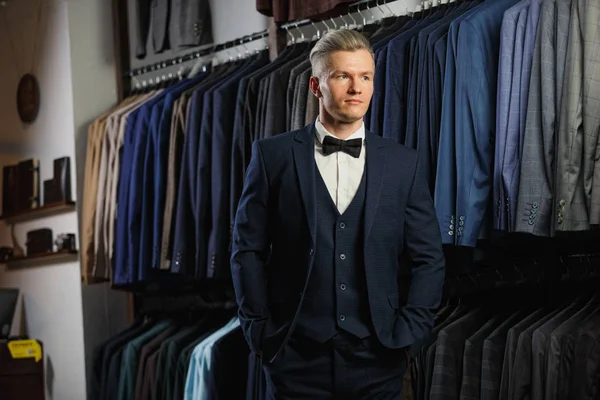 Guapo hombre de negocios caucásico vestido con el traje en la tienda de traje — Foto de Stock