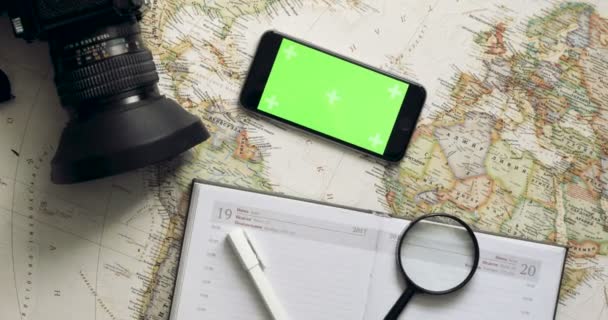 上記から携帯電話のアプリ ビンテージ デスクを使用して休暇を計画平面図旅行者 — ストック動画
