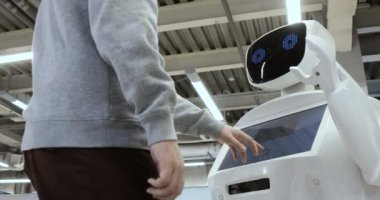 Novosibirsk Rusya - 01.22.2018: Sibernetik sistem bugün. Modern robotik teknolojiler. Özerk insansı robot. onun değmek perde kullanan bir adam. Yüksek teknoloji sistemi bugün. Toplumda yenilikçi Yardımcısı