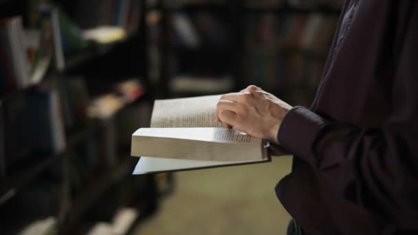 Student reading a book in the library. education concept — Stock Video