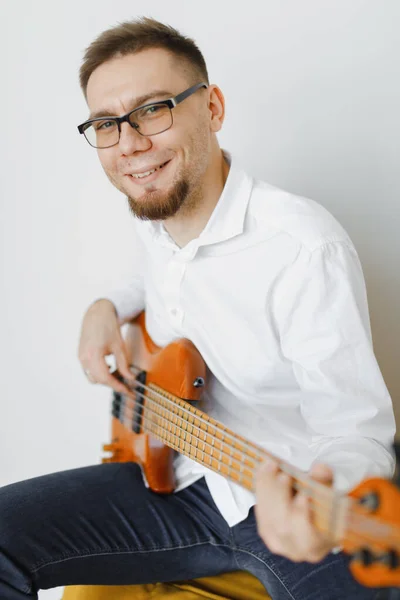 stock image Practicing in playing guitar. Handsome young men playing guitar