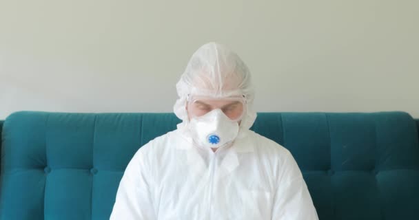 Portrait of doctor in protective suit with inscription hashtag stay at home. — Stock Video