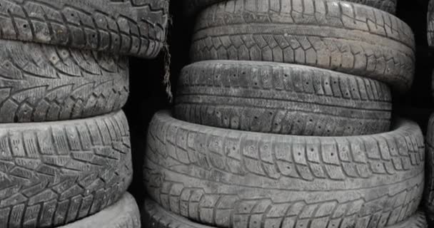 Stacks of used rubber car tires at processing recycling plant, closeup. — Stock Video