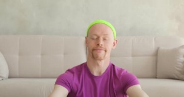 Nilüfer yogasında meditasyon yapan bir adam evde oturma odasında oturuyor..