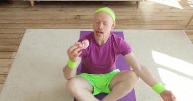 Komik adam paspasın üzerine düşüp yoga pozu veriyor, evde çörek yiyor..