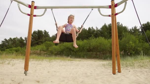 4k Beautiful little girl on a swing Baltic Sea in Jurmala, Latvia. — Stock Video