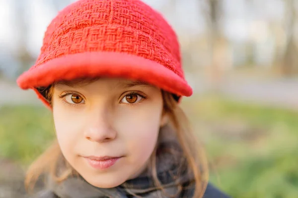 Little beautiful smiling girl in red hat — Stock Photo, Image