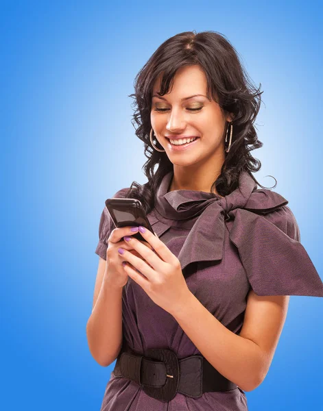 Charming girl reads sms on phone — Stock Photo, Image
