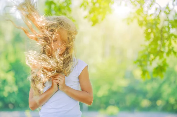 Smiling beautiful teenage wind with flying hair — Stock Photo, Image