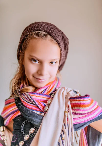 Little smiling girl in a cap and a long scarf — Stock Photo, Image